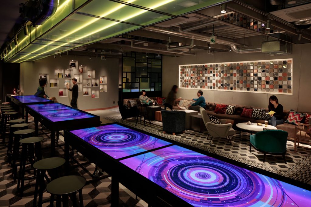 The Millennials Shibuya lobby with sofas and tables with led tops and barstools