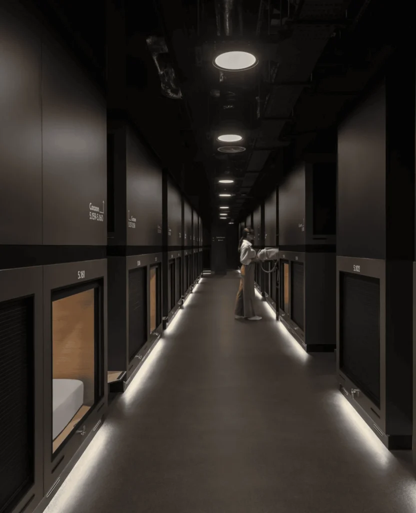 Long black corridor with rows of capsules